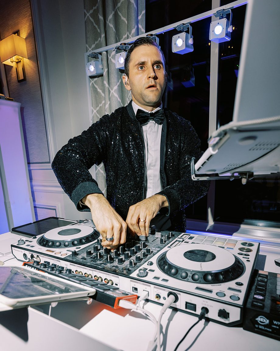 DJ Dayve mixing in a sequin jacket