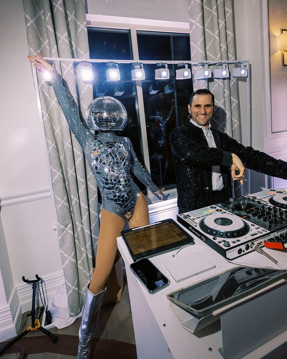 DJ Dayve with a mirror-ball performer at the booth