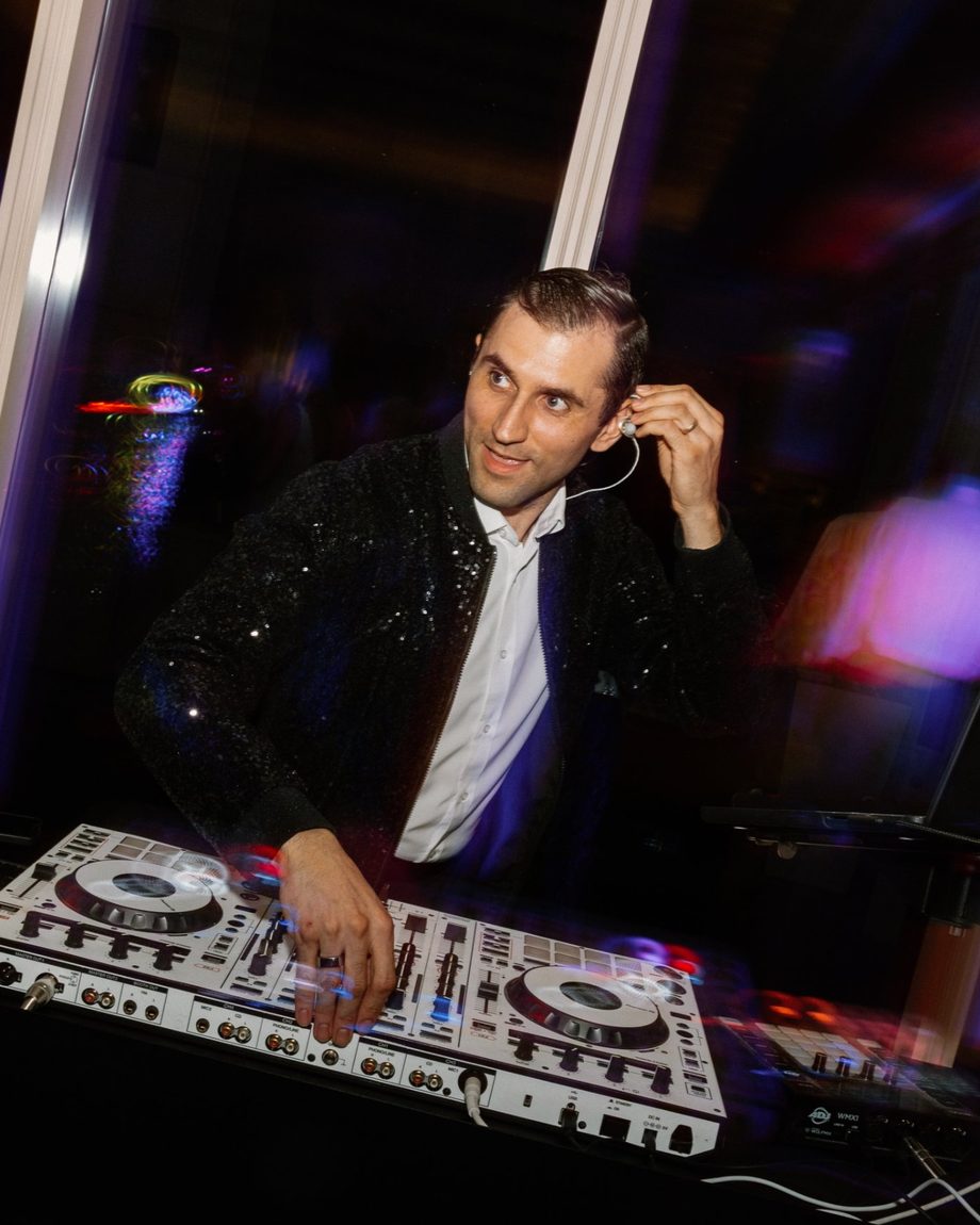 DJ Dayve adjusting his in-ear monitor mid-set