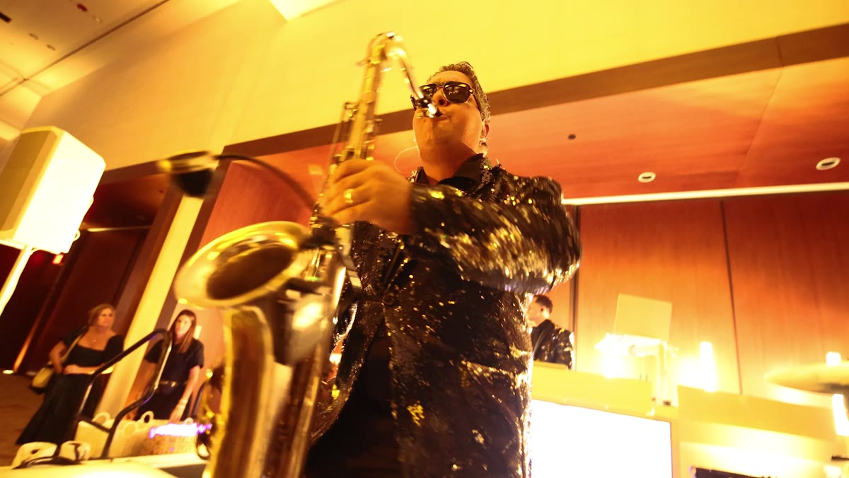 Saxophonist playing over the DJ set